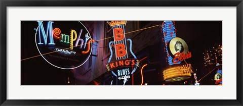 Framed Low angle view of neon signs lit up at night, Beale Street, Memphis, Tennessee, USA Print