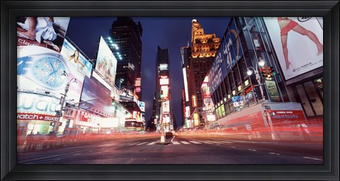 Framed Low angle view of sign boards lit up at night, Times Square, New York City, New York, USA Print