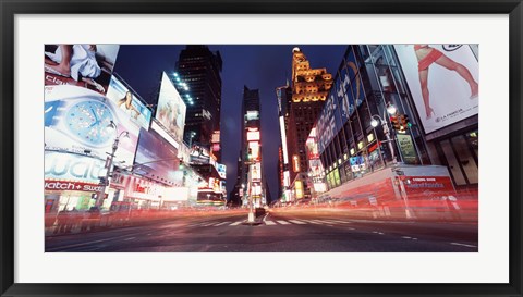 Framed Low angle view of sign boards lit up at night, Times Square, New York City, New York, USA Print