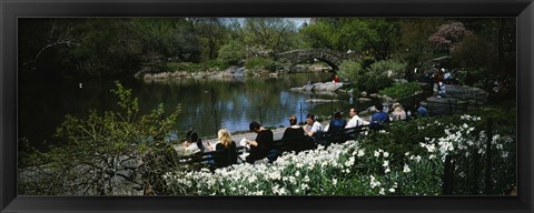 Framed Group of people sitting on benches near a pond, Central Park, Manhattan, New York City, New York State, USA Print