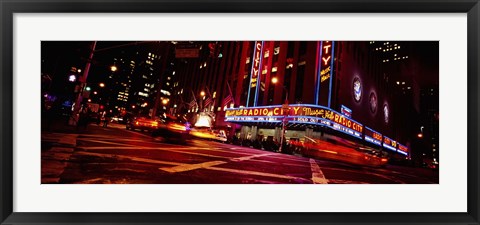 Framed Low angle view of buildings at night, Radio City Music Hall, Rockefeller Center, Manhattan, New York City, New York State, USA Print