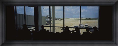Framed Silhouette of a group of people at an airport lounge, Orlando International Airport, Orlando, Florida, USA Print
