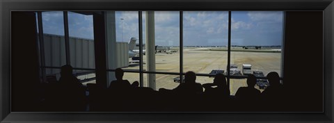 Framed Silhouette of a group of people at an airport lounge, Orlando International Airport, Orlando, Florida, USA Print