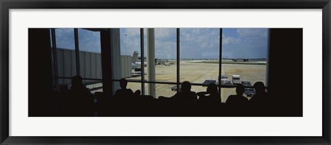 Framed Silhouette of a group of people at an airport lounge, Orlando International Airport, Orlando, Florida, USA Print