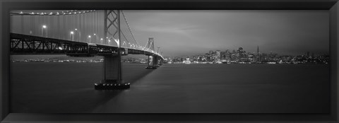 Framed Low angle view of a suspension bridge lit up at night, Bay Bridge, San Francisco, California, USA Print