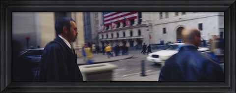 Framed Two people walking, New York Stock Exchange, Wall Street, Times Square, Manhattan, New York City, New York State, USA Print