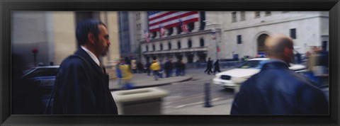 Framed Two people walking, New York Stock Exchange, Wall Street, Times Square, Manhattan, New York City, New York State, USA Print