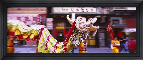 Framed Group of people performing dragon dancing on a road, Chinatown, San Francisco, California, USA Print