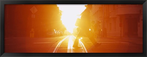 Framed Side profile of a person crossing the cable car tracks at sunset, San Francisco, California, USA Print