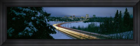 Framed Autumobile lights on busy street, distant city lights, frozen Westchester Lagoon, Anchorage, Alaska, USA. Print