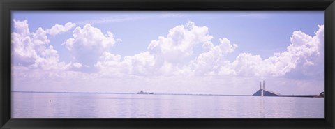 Framed Sea with a container ship and a suspension bridge in distant, Sunshine Skyway Bridge, Tampa Bay, Gulf of Mexico, Florida, USA Print