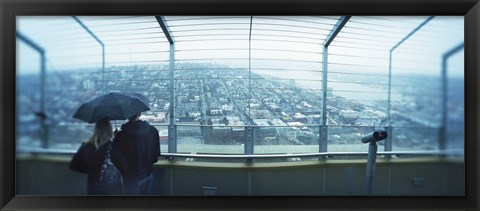 Framed Couple viewing a city from the Space Needle, Queen Anne Hill, Seattle, Washington State, USA Print