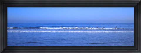 Framed Surfers riding a wave in the sea, Santa Monica, Los Angeles County, California, USA Print