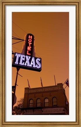 Framed Low angle view of a neon sign of a hotel lit up at dusk, Fort Worth Stockyards, Fort Worth, Texas, USA Print