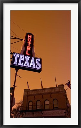 Framed Low angle view of a neon sign of a hotel lit up at dusk, Fort Worth Stockyards, Fort Worth, Texas, USA Print