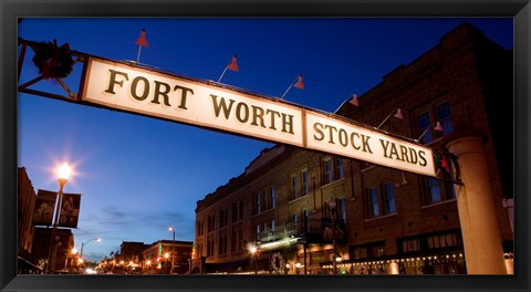 Framed Signboard over a road at dusk, Fort Worth Stockyards, Fort Worth, Texas, USA Print