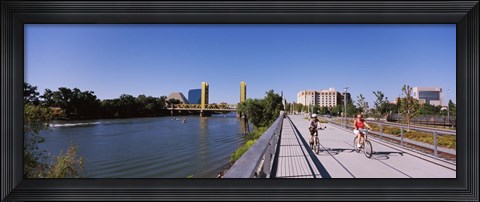 Framed Bicyclists along the Sacramento River with Tower Bridge in background, Sacramento, Sacramento County, California, USA Print