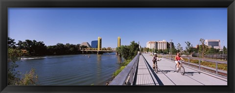 Framed Bicyclists along the Sacramento River with Tower Bridge in background, Sacramento, Sacramento County, California, USA Print