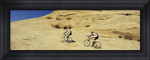 Framed Side profile of two men mountain bilking on rocks, Slickrock Trail, Moab, Utah, USA Print