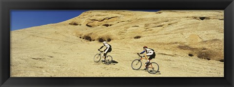 Framed Side profile of two men mountain bilking on rocks, Slickrock Trail, Moab, Utah, USA Print