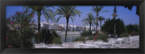 Framed Sidewalk cafe at the riverside, Guadalquivir River, Seville, Spain Print