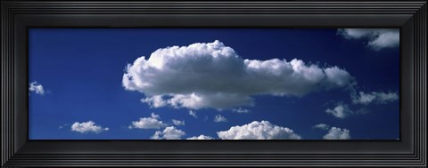 Framed Fluffy clouds in blue sky Print
