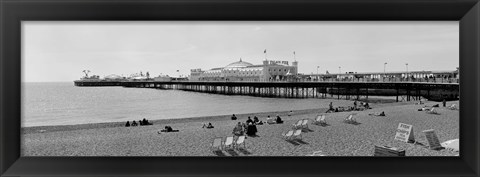 Framed Tourists on the beach, Brighton, England Print