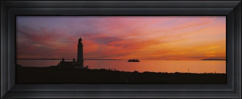 Framed Silhouette of a lighthouse at sunset, Scotland Print