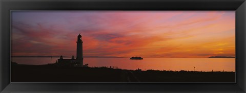 Framed Silhouette of a lighthouse at sunset, Scotland Print