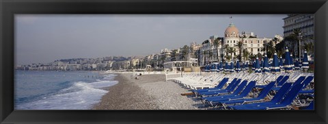 Framed Empty lounge chairs on the beach, Nice, French Riviera, France Print