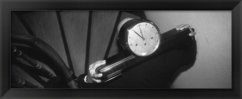 Framed Man Carrying Clock Up Stairs On Shoulders Print