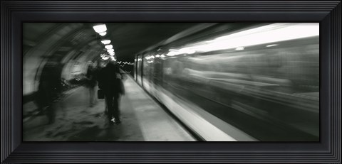 Framed Subway train passing through a subway station, London, England Print