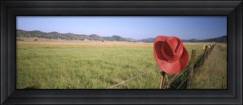 Framed USA, California, Red cowboy hat hanging on the fence Print