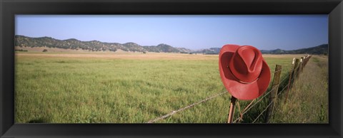 Framed USA, California, Red cowboy hat hanging on the fence Print