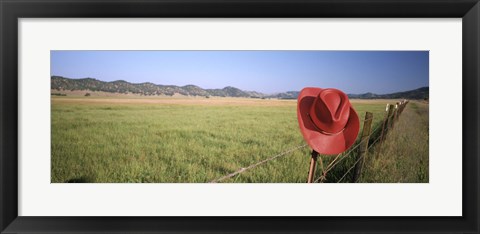 Framed USA, California, Red cowboy hat hanging on the fence Print