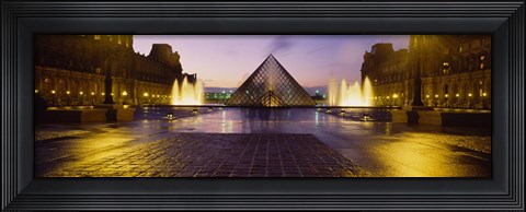 Framed Museum lit up at night with ghosted image of three men, Louvre Museum, Paris, France Print