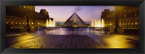 Framed Museum lit up at night with ghosted image of three men, Louvre Museum, Paris, France Print