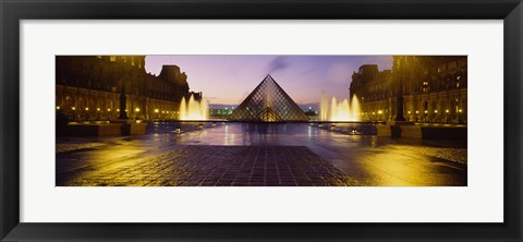 Framed Museum lit up at night with ghosted image of three men, Louvre Museum, Paris, France Print