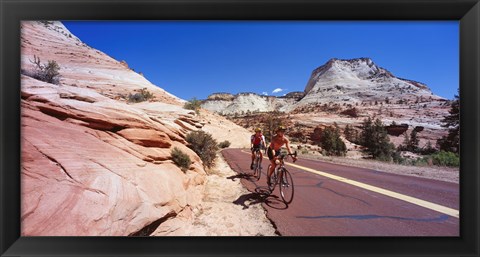 Framed Two people cycling on the road, Zion National Park, Utah, USA Print