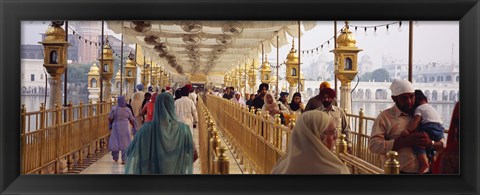 Framed Group of people walking on a bridge over a pond, Golden Temple, Amritsar, Punjab, India Print