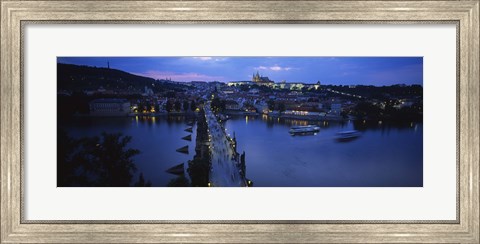 Framed High angle view of buildings lit up at dusk, Charles Bridge, Vltava River, Prague, Czech Republic Print