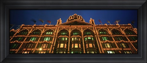 Framed Low angle view of a building lit up at night, Harrods, London, England Print