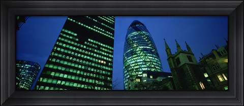 Framed Low angle view of buildings lit up at night, Sir Norman Foster Building, Swiss Re Tower, London, England Print