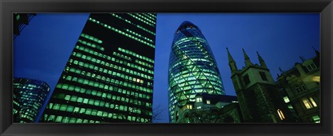 Framed Low angle view of buildings lit up at night, Sir Norman Foster Building, Swiss Re Tower, London, England Print