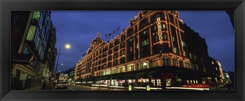 Framed Low angle view of buildings lit up at night, Harrods, London, England Print