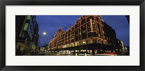 Framed Low angle view of buildings lit up at night, Harrods, London, England Print