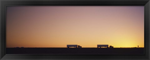 Framed Silhouette of two trucks moving on a highway, Interstate 5, California, USA Print