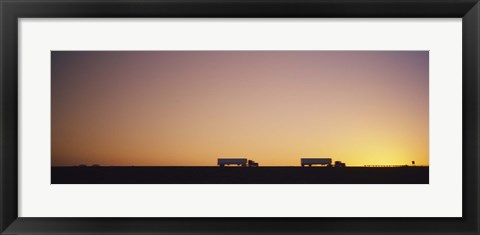 Framed Silhouette of two trucks moving on a highway, Interstate 5, California, USA Print