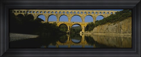 Framed Reflection of an arch bridge in a river, Pont Du Gard, France Print