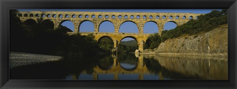 Framed Reflection of an arch bridge in a river, Pont Du Gard, France Print